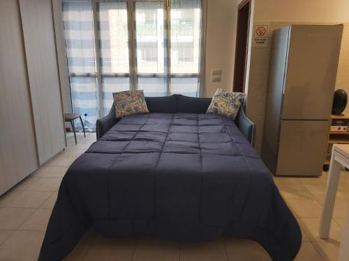 a large bed in a room with a large window at Casa Sole in Vimodrone