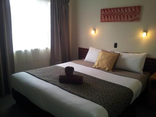 a bedroom with a bed with a box on it at A-Frame Chalets @ Mokutu in Burnt Pine