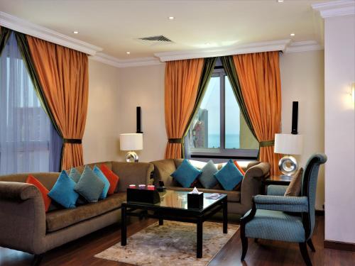 a living room with a couch and a table at Boudl Salmiya, Kuwait - بودل السالمية الكويت in Kuwait
