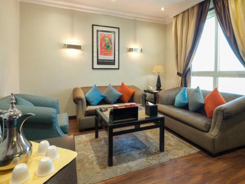 a living room with two couches and a coffee table at Boudl Salmiya, Kuwait - بودل السالمية الكويت in Kuwait