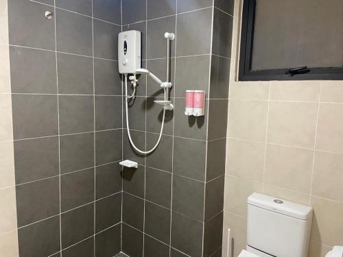 a shower in a bathroom with a toilet at Nice Studio Unit at Tiara Imperio Bangi in Kajang