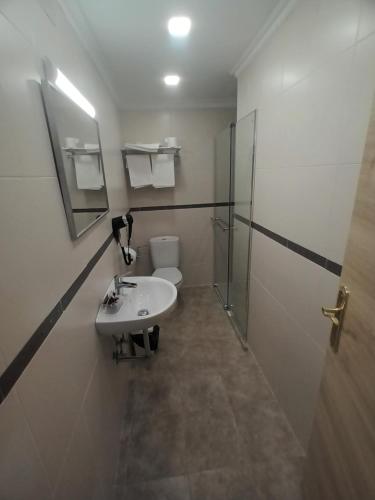 a bathroom with a sink and a shower and a toilet at Hostal Can Jaume in Mollerusa