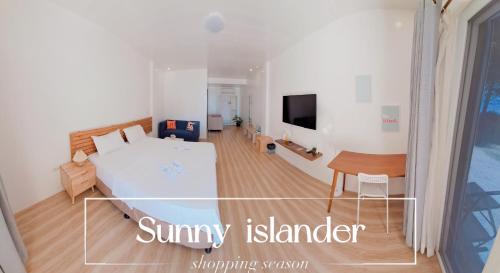 een slaapkamer met een bed en een bureau in een kamer bij sunny islander diving resort in Looc