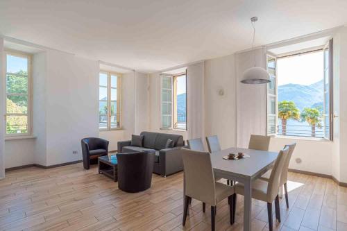a living room with a table and a couch at Maioliche Apartments Griante in Griante Cadenabbia