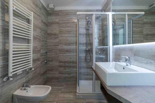a bathroom with a sink and a shower and a toilet at Maioliche Apartments Griante in Griante Cadenabbia