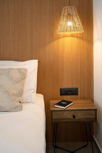 a bedroom with a bed and a table with a book at Milatos Seaside Suites in Milatos