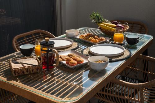 a table with a tray of breakfast foods on it at Milatos Seaside Suites in Milatos