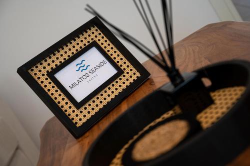 a table with a sign on it with a pair of scissors at Milatos Seaside Suites in Milatos