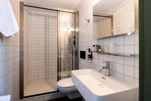 a bathroom with a toilet and a sink and a shower at Pilo Lyon in Lyon