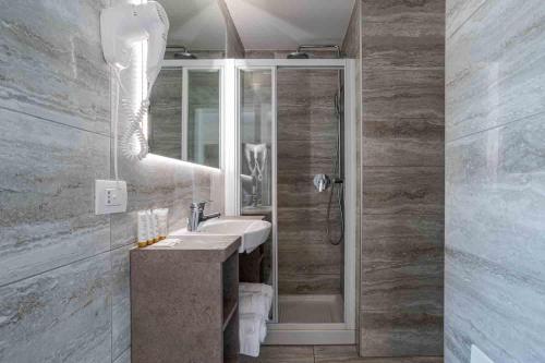 a bathroom with a sink and a shower at Maioliche Apartments Griante in Griante Cadenabbia