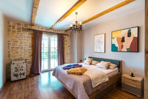 a bedroom with a bed and a brick wall at Stylish & luxury villa with pool, biliard, extra pool heating available in Pula