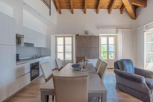 a kitchen and dining room with a table and chairs at Maioliche Apartments Griante in Griante Cadenabbia