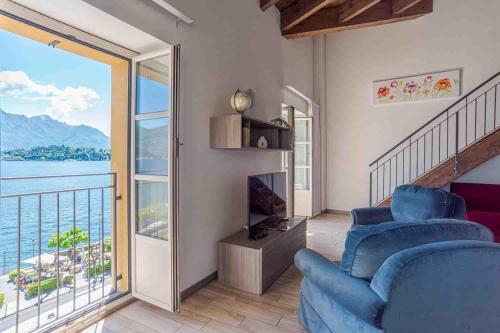 a living room with a view of the water at Maioliche Apartments Griante in Griante Cadenabbia