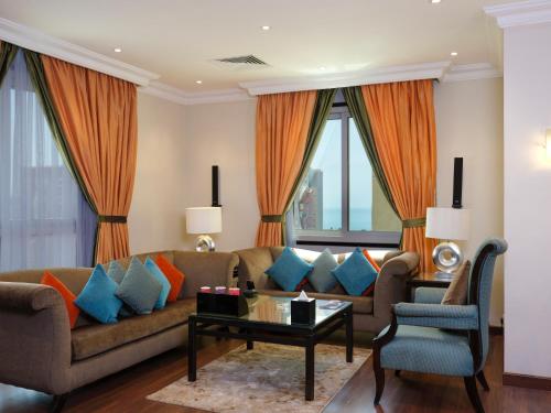 a living room with a couch and a table at Boudl Salmiya, Kuwait - بودل السالمية الكويت in Kuwait