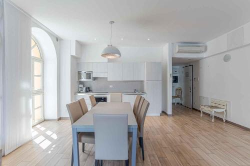 a kitchen and dining room with a table and chairs at Maioliche Apartments Griante in Griante Cadenabbia