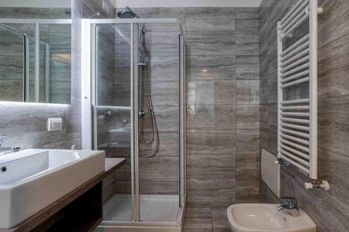 a bathroom with a shower and a sink and a toilet at Maioliche Apartments Griante in Griante Cadenabbia