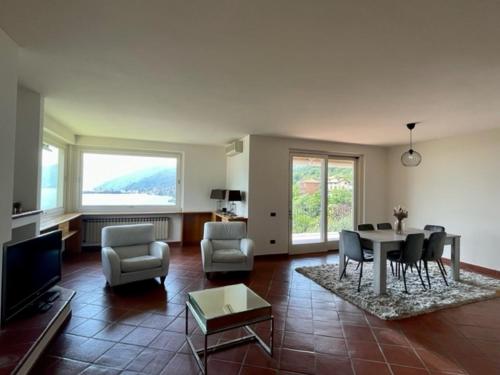 a living room with a table and chairs at Casa CAPONETTI in Costa Volpino