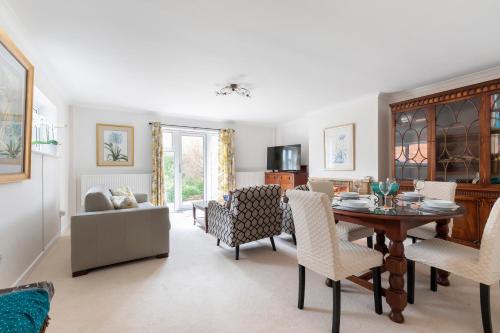 a living room with a dining room table and chairs at Luxury Cheltenham Home with EV charger - Lechampton Hills in Cheltenham