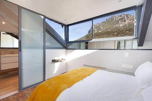 a bedroom with a bed with a large window at Harbour facing Penthouse in Cape Town