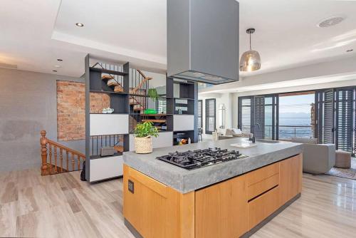 a kitchen with a stove top oven in a room at Harbour facing Penthouse in Cape Town