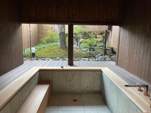 a jacuzzi tub in the middle of a house at LiveGRACE House Lake Saiko 西湖古民家 in Yamanashi