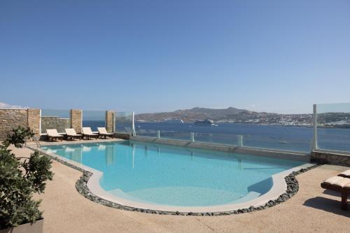 a swimming pool with a view of the water at Amaris Mykonian Residence in Ornos
