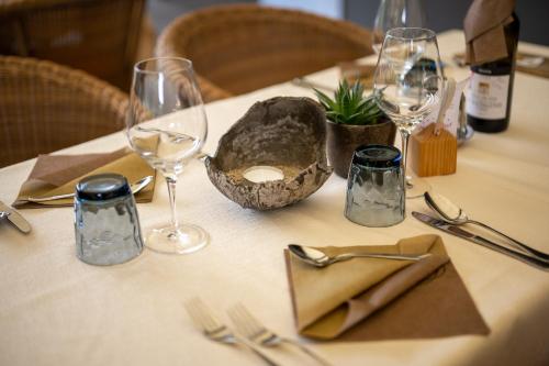 a table with wine glasses and silverware on it at Hotel Rierhof in Chiusa