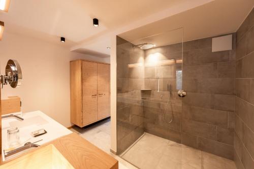 a bathroom with a shower and a sink at Hotel Rierhof in Chiusa