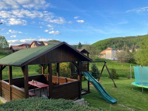 a gazebo with a slide and a playground at Chata Adela in Svätý Anton