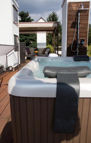 a hot tub on the deck of a house at Hotel San Rocco in Orta San Giulio