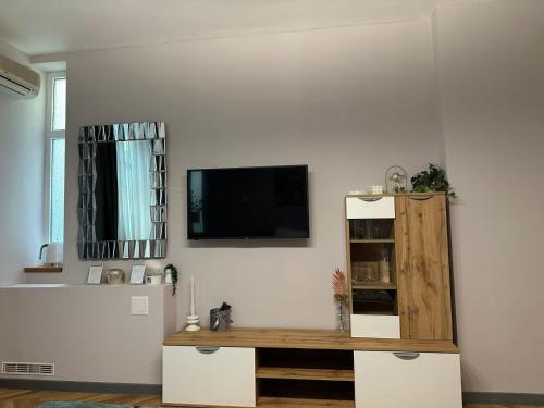 a living room with a tv on a white wall at Lux apartments Top center in Sofia