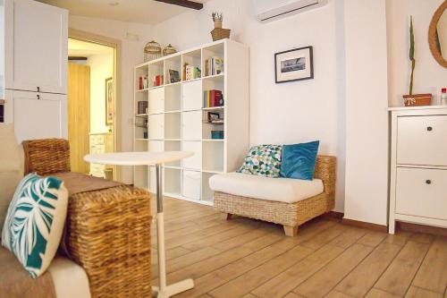 a living room with a table and a chair at LAVINIA'S SWEET HOME in Caserta