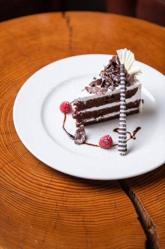 a piece of chocolate cake on a plate on a table at Acacia Premier Hotel in Kisumu
