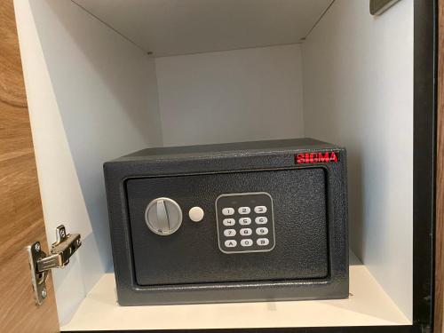a black safe sitting inside of a door at Bonanza Apartments in Niš