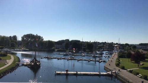 a group of boats are docked in a river at Le coin de mire in Carentan
