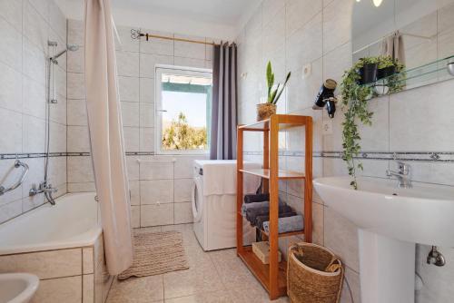 a bathroom with a sink and a tub and a toilet at La Finca Las Estrellas in Tarajalejo