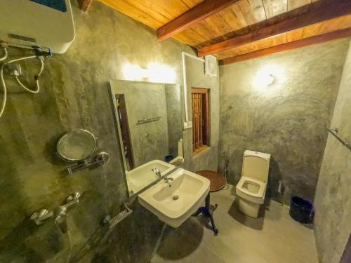 a bathroom with a sink and a toilet at The Cove Pasikuda - Eco Resort in Pasikuda