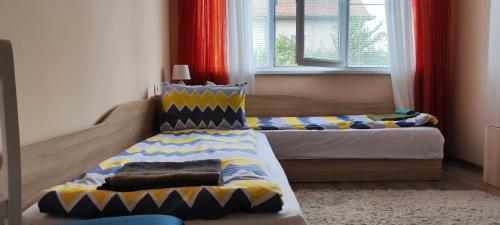 a bedroom with two beds in a room at Guest House Krasi in Ovoshtnik