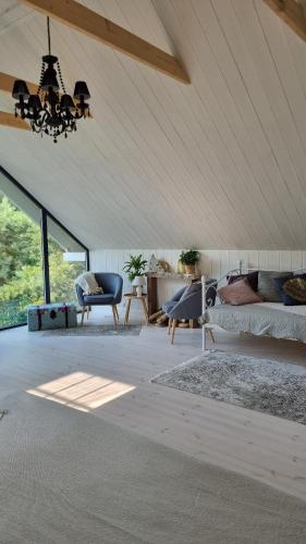 a living room with a bed and a chandelier at DIENVIDI in Bernāti