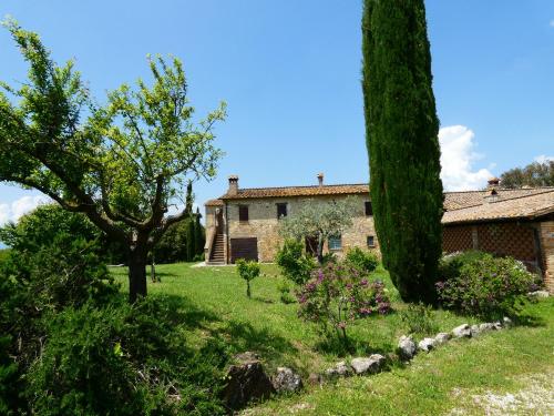 an old stone house with trees and green grass at SCAPPO IN UMBRIA, Casale Monti in Montoro