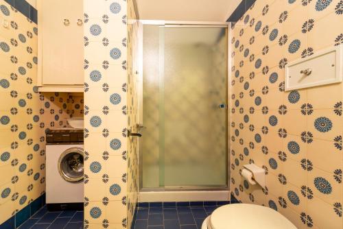 a bathroom with a shower with a toilet in it at Ca' Furmiga by Wonderful Italy in Lenno
