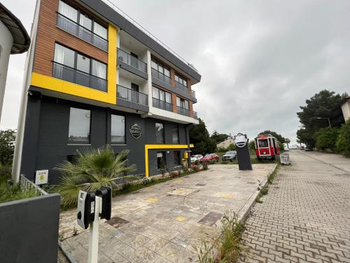 a building with a parking lot in front of it at Deluxe Beach Residence in Samsun