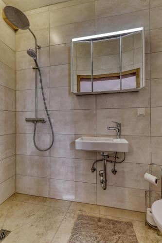 a bathroom with a sink and a mirror and a shower at Hotel Bayerischer Hof in Bodenmais