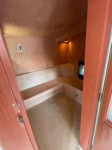 a small empty room with a television in it at Luxury studio with private pool in Binisafua