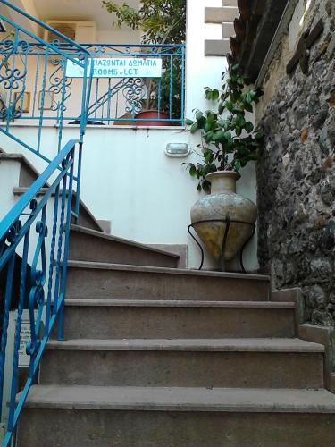 a set of stairs with a pot with a plant in it at Karagiannaki in Skála Sykaminéas