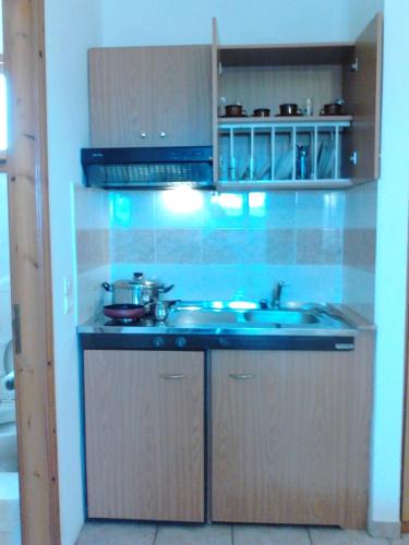 a kitchen with a sink and a stove at Karagiannaki in Skála Sykaminéas
