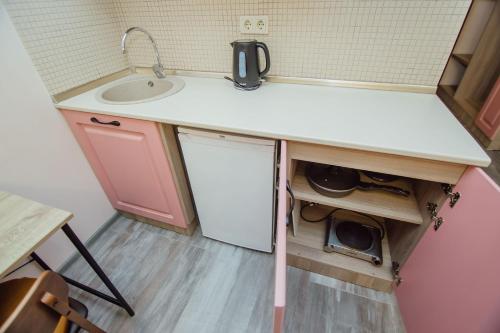 a small kitchen with a sink and a sinkessment at Real Beach Tower in Batumi