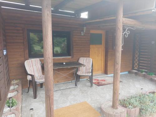 a patio with a table and chairs in a cabin at Ferienwohnungen! Kleine Bungalows mit Terrasse! in Stockhausen-Illfurth