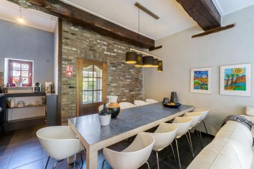 a dining room with a table and chairs at Meschermolen 3 in Withuis