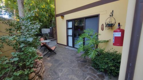 a house with a fire hydrant on the side of it at Maison Ambre Guesthouse in Windhoek